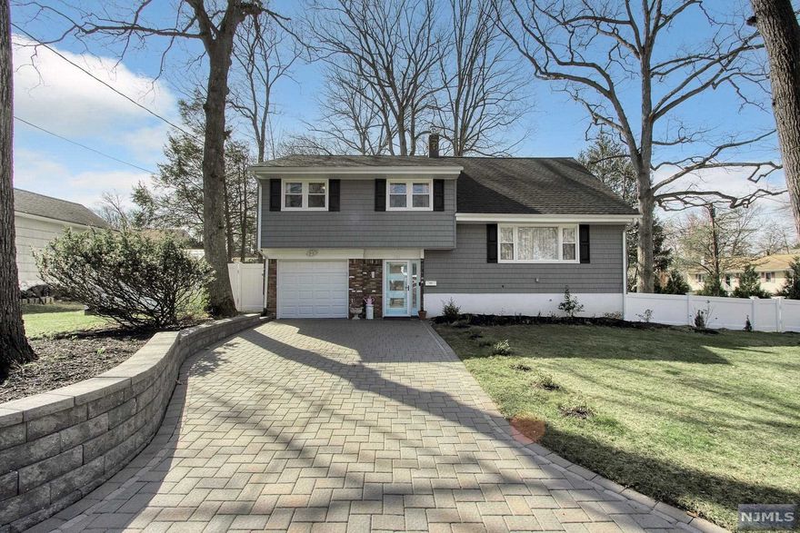 Immaculate move-in ready expanded home with updates throughout. Welcoming entry foyer which leads into a large family room with a laundry room/half bath. Access to the backyard from this level. A few stairs up features a large living room with fireplace, and spacious dining room. Beautifully updated eat-in kitchen featuring custom white cabinets, granite countertops, peninsula/breakfast bar and stainless steel appliances. Three large bedrooms and a modern full bath on the second level. Third level offers a luxurious primary suite including ample closets and a modern full bath. Lush, professionally landscaped property offers a fenced-in backyard with a patio. Paver driveway and attached garage complete this home. Great location, close to the center of town!