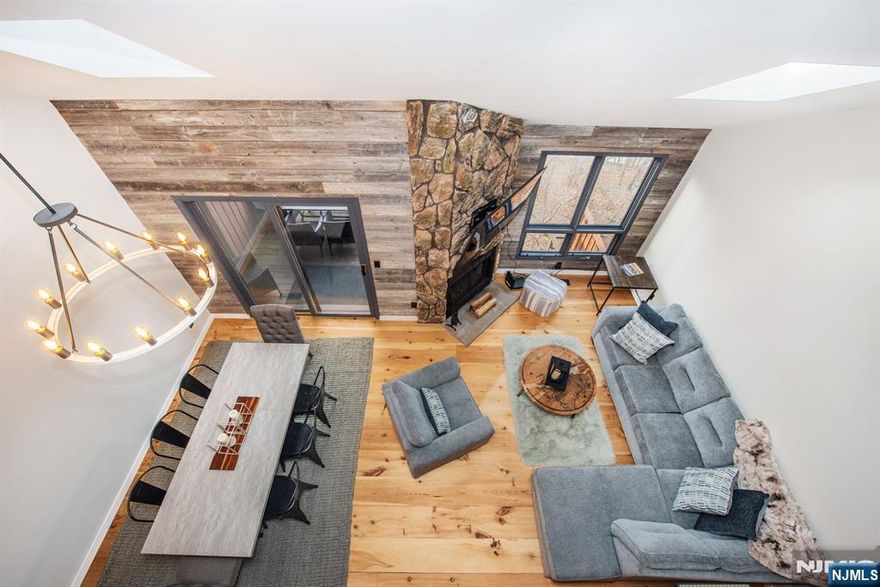 Discover serenity in this stunning mountain-townhouse in Vernon, New Jersey - with just the right amount of rustic textures throughout! Notice the vaulted ceilings, large windows and skylights - collectively capturing the surrounding natural beauty of this location. Next, the open-concept living room w/ wood burning fireplace and dining area w/dry bar flow effortlessly to a private deck - you'll enjoy both spacious comfort and immersive nature vibes. The kitchen is perfect to create cozy meals after a day hiking or skiing nearby. Relax and unwind in the loft/bedroom or the primary bedroom with 2 sliders, plenty of closet space and a private deck. Nestled in a tranquil community yet just minutes from golfing and skiing - this home offers the ideal blend of retreat and convenience. Are you ready to own a meticulous home - that combines design elements from the best of the NYC and the charm of mountains along with being on the same premises as Mineral Resort & Spa- don't wait - this is your year! (2 TVs and Ring Doorbell are included. Furniture is negotiable.)