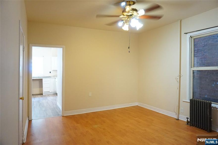 Freshly updated 3-bedroom, 1-bath apartment featuring newer flooring and fresh paint throughout. This spacious unit includes a bonus room perfect for a home office, nursery, or additional storage. Enjoy access to a private backyard exclusively for tenant use. Heat is included in the rent. Section 8 welcome. Conveniently located near shopping, local amenities, and transportation to NYC for easy commuting.