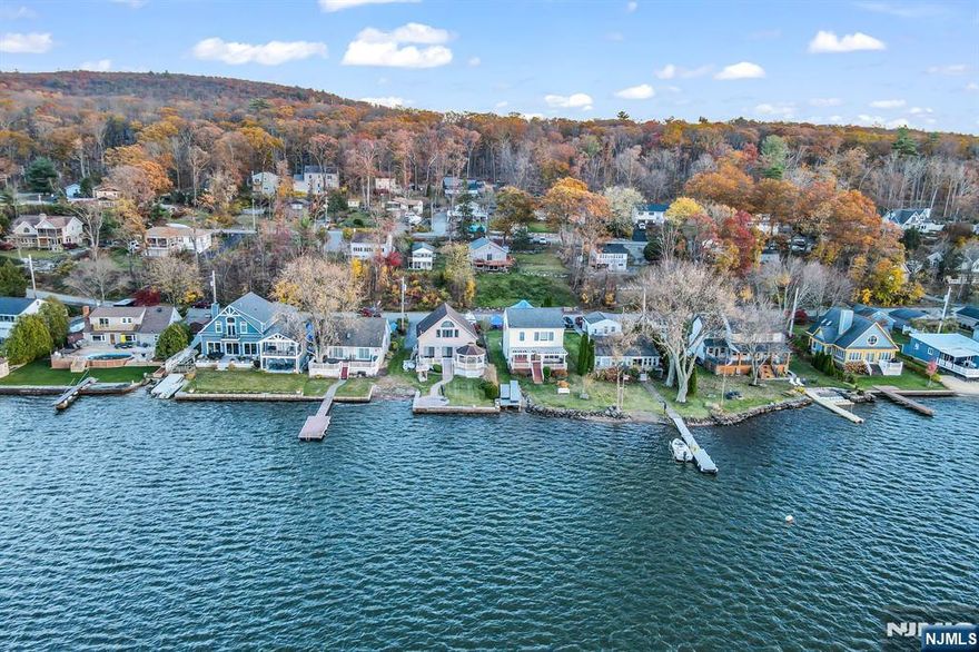 Welcome To This Breathtaking 2 Bedroom, 2 Bath Lakefront Dream Home On Greenwood Lake's Sought-After Eastern Shore! From The Moment You Step Inside The Dramatic Two-Story Foyer, The Open Floor Plan Draws Your Eye Straight Through To A Stunning Wall Of Sliding Glass Doors Framing Endless Water Views And Unforgettable Sunsets! The Premium Kitchen Features Granite Countertops And Opens Seamlessly To The Living Area, Complete With A Custom Granite Bar Ideal For Entertaining! The Main Level Offers A Spacious Open Living And Dining Room, A First-Floor Primary Bedroom, And An Elegant Full Bath! Upstairs, You'll Find A Second Bedroom, A Versatile Den/Loft Space, And Another Full Bath, All Enhanced By Soaring Ceilings And A Showcase Arched Window Overlooking The Lake! Step Outside To The Expansive Rear Deck With A Built-In Gazebo, Offering Covered Lakefront Enjoyment In Every Season! Whether Boating, Kayaking, Swimming, Or Simply Unwinding, You'll Love Everything Greenwood Lake Has To Offer! Just One Hour From NYC. This Is Lakefront Living At Its Finest. Schedule Your Showing Today!