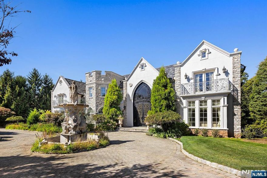 Set on one of the most sought after streets in northeastern Bergen County, this 12,000 square foot mansion abounds in luxury. Designed by premier architect, Zampolin & Associates, no detail has been overlooked. With east/west exposure, the home is flooded with beautiful sunrise and sunset light. Upper and lower floors open to terraces that extend the full length of the home, perfect for sunset soirees. A dramatic double staircase showcases the marble entrance with soaring 22 foot ceilings. The expansive kitchen will inspire your inner chef, while the formal living room's built-in bar is ideal for cocktails. Relax by the fireplace, or retreat to the sumptuous primary suite with its own fireplace, balcony, and sitting room. Seven additional bedroom suites, including one on the main floor offer ample accommodations, and the perfect setup for multi-generational living. On the lower level, enjoy a movie in the theater or a game of squash on the indoor court. Additional features include an elevator to all three floors, hand-carved marble, heated floors, a serene natural pond, gazebo, summer kitchen, French doors throughout, and so much more. This home is truly an entertainer's dream and a must see. Call Annitsa @ 201-406-3650 for more information.