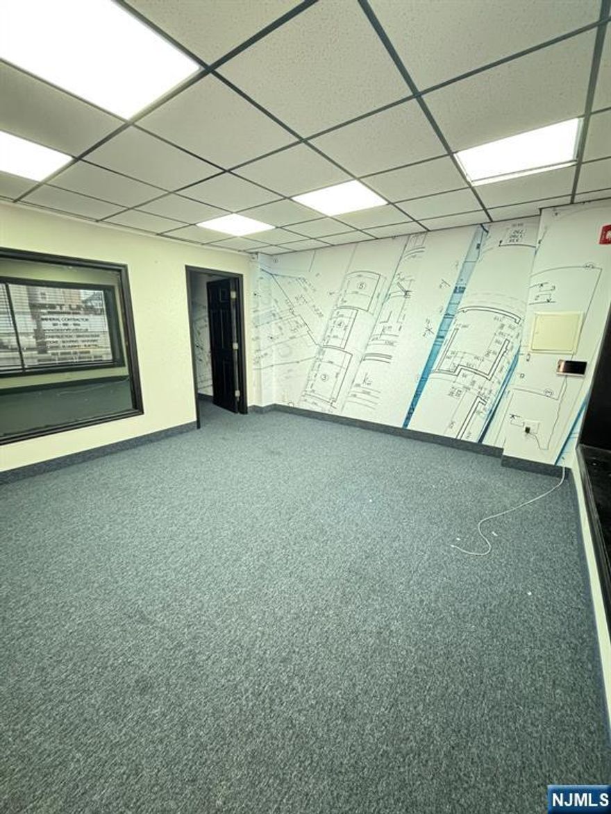 Highly visible corner spot with new floors (carpeting), paint and updated half-bathroom. Lots of natural light, one off street parking space included. Zoned as M-1- can be great as an office, showroom or social club. Landlord will pay for a change of use variance.