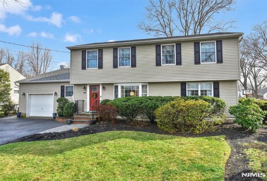 Welcome to this lovingly maintained, spacious 5 bedroom, 3 bath colonial in the heart of Paramus. The charming curb appeal and mature landscaping give a wonderful first impression and once inside, there is ample space for a large, extended family, with plenty of room to entertain! Step into the welcoming entry foyer, which opens to the spacious living room with large bay window - a perfect gathering space. Continue to the formal dining room and down the hall to the original primary bedroom, additional bedroom (or office) and updated full bath. The eat-in kitchen with center island and walk-in pantry provides ample counter, dining and storage space, as well as room to gather/host. Access the one-car garage via the kitchen. Off the kitchen, you can retreat to the warm, large and inviting family room, with full masonry, wood-burning fireplace, and ample room for all! From there, access the covered deck (new railings), paver patio and fully fenced in, private, lush backyard. The second floor features the large primary bedroom with ensuite bathroom and spacious/organized walk-in closet, 2 additional well appointed bedrooms and full bathroom. The basement includes laundry, a large cedar storage closet and a finished area with so much potential! This home has been updated, well loved and cared for by two generations. Don't miss this gem!