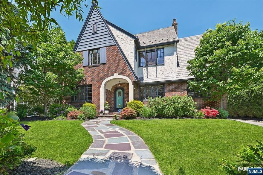 Back and better than everâ€”reintroducing 66 Dodd St! This storybook Tudor blends timeless charm with modern comforts, including a stunning renovated kitchen with natural stone counters and Jenn-Air appliances. Sunlight floods the family room through skylights, and the first floor also features a sunroom, cozy den, formal dining room, and living room with leaded windows and a wood-burning fireplace. Upstairs, the primary suite offers a marble bath, cedar closets, and a lounge with sweeping views of the pool and gardens. Two more bedrooms share a renovated hall bath with soaking tub and 6-jet Kohler shower. The third floor features two additional bedrooms, one with an en-suite. A finished basement includes a wet bar, oversized pantry, and new laundry area with chute. Enjoy a heated saltwater pool, blue stone patio, and lush fenced yardâ€”close to Brookdale Park, NYC transit, and Montclair dining.