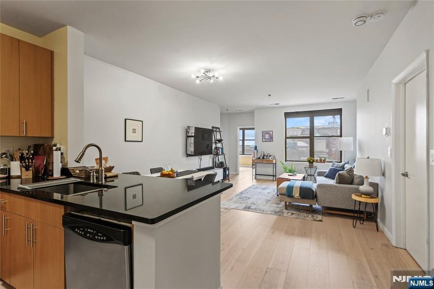 Experience breathtaking southeast views of NYC and the Hudson River in this prestigious 2-bed 2-bath home located in the sought-after Hudson Club. This 1017sqft residence is filled w/natural light throughout the day, illuminating every room. Step inside to discover an open-style main floor w/brand new wood flooring, a chef's kitchen boasting SS appliances, seamlessly flowing into the dining & living areas. The split bedroom layout offers privacy, w/a spacious primary ensuite & generous 2nd bedroom. Enjoy the in-unit washer/dryer and 1-car parking. The HOA covers all utilities, cable/internet (excluding electric). The community offers a pool, concierge, clubhouse w/fitness center, business center, basketball court, cinema room, community lounge, firepits, and an electric charging station. Enjoy easy access to NYC/NJ w/the Ferry, Light rail, & NJ Transit conveniently nearby. Direct access to ACME, Starbucks, stores, and restaurants in close proximity. Don't miss out!