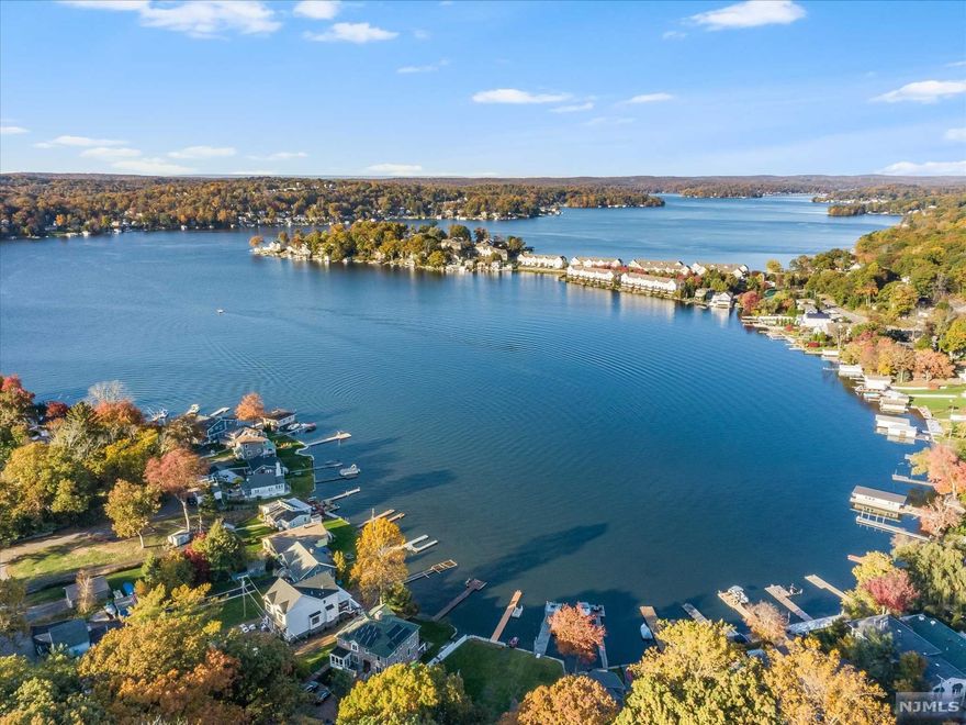 Enjoy spectacular lake views and gorgeous sunsets from this newly renovated ranch perched atop a 1/2 acre corner lot. This home is its own private retreat with huge backyard patio with hot tub, pool and entertaining areas. This home is farm country chic with its new eat in kitchen, designed with white cabinets, natural oak countertops, stainless steel farm sink, and oil rubbed hardware.Its breakfast nook has its own corner views of Lake Hopatcong and basks every evening in the afterglow of the sunset. The first floor features a spacious floor plan with traditional living room with stone fireplace with deep wood burning hearth,original oak hardwood floors and open to an expansive outside deck that wraps around the entire front and side facing the lake, eat in kitchen, formal dining room, family room, two bedrooms & main bath.The ground level offers two bedrooms, one bath, recreation room, laundry room,workshop/storage room wgarage entrance. The home has been totally refreshed