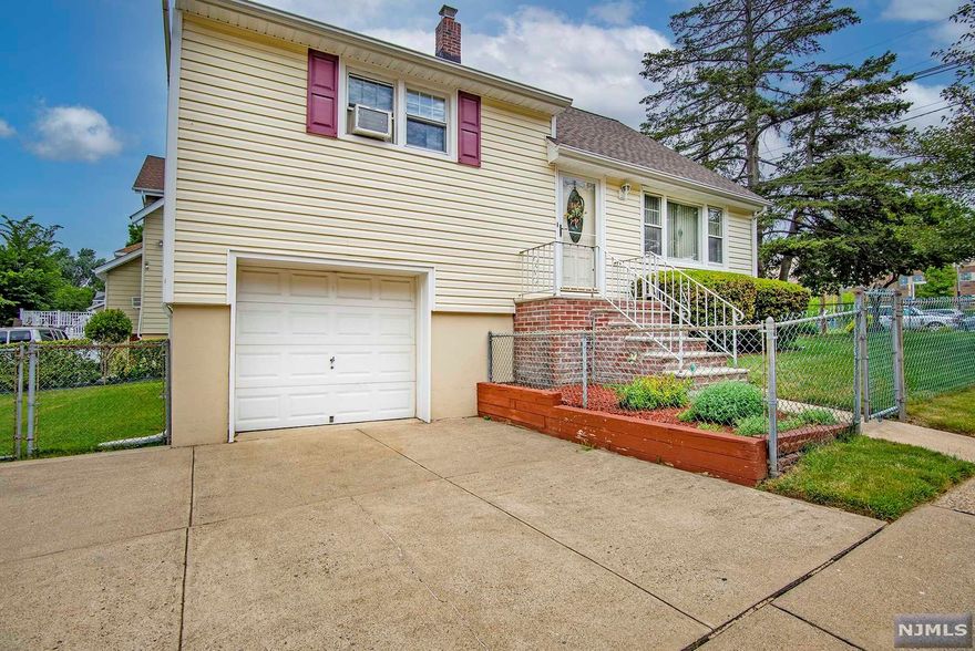 This spacious split level home has so much to offer and has been meticulously maintained inside & out. Great pride of ownership at an exceptional value! New furnace in approx 2015, new vinyl siding in approx 2012, and a new roof in approx 2010. The oversized corner property has a huge fenced-in yard with a shed for extra storage. You'll also love all the natural light (South/East exposure), the true eat-in-kitchen w/ separate side entrance, attached garage w/ direct entry into the home plus bonus workshop area, 150 amp electrical panel, and the large basement w/ high ceilings (so much potential to be finished to your liking). Prime commuter location near NYC transit, schools, parks and shopping.