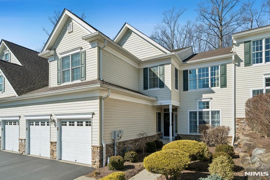 This beautifully maintained 3-bedroom, 3.1-bath residence with a 2-car garage offers refined living with thoughtful upgrades and exceptional space for entertaining. The foyer upon entry is greeted with hardwood floors and a stunning two-story living room and a formal dining room with tray ceiling and crown molding. The inviting great room with gas fireplace flows into the open kitchen featuring granite countertops, center island, and bright breakfast area with sliders to a composite deck perfect for relaxing or outdoor dining. A pellet grill (never used) is included. The main level also features a private den with custom cabinetry, ideal for a home office or reading retreat. Throughout the home you'll find custom draperies, tailored valances, and motorized blinds in the kitchen and primary bedroom. Upstairs offers three generously sized bedrooms. The primary suite features a sitting area and spa-inspired bath with heated floors, double sinks, soaking tub, and walk-in shower. The hall bath has been tastefully updated with double sinks and a modern walk-in shower. The finished waterproofed basement expands the home's lifestyle appeal with a wet bar, beverage refrigerator, recreation area, exercise room, and flexible entertaining space. Located in an active adult community, offering low-maintenance living close to shopping, dining, and major commuter routes. Meticulously maintained and truly move-in ready; schedule your showing today!