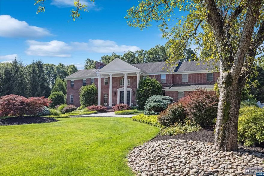 This stunning colonial estate offers high-end finishes, 7 beds,6.5 baths. Enter to a grand 2-story foyer leading to a living room with fireplace, dining room, family room with fireplace, office, and gourmet kitchen with Sub-Zero appliances and pantry. A guest suite, in-law suite, 2 full baths, and laundry complete the main level. Venture upstairs to find an oversized primary suite with sitting room and fireplace, primary bath with radiant heat, and 4 additional bedrooms with 2 full baths. The lower level includes a rec room, media room, sauna, gym, and plenty of storage. The meticulously landscaped outdoor area is a true oasis, offering a seamless blend of luxury and tranquility. Step outside to discover a beautiful saltwater pool, providing the perfect retreat for those warm summer days. Unwind in the soothing spa, complete with a cascading waterfall feature that adds a touch of serenity to the space. A 3 car garage and circular driveway add elegance to this magnificent home.