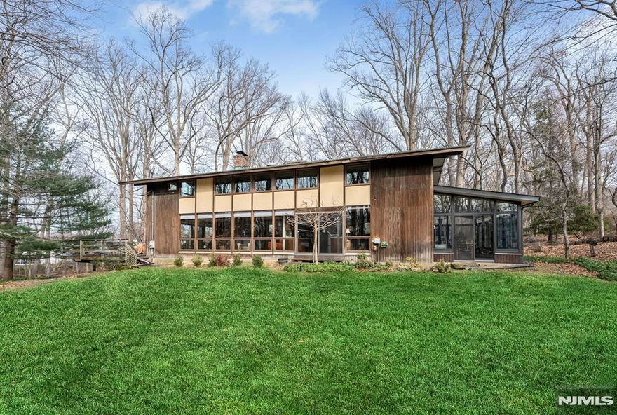 Prime East Hill location on approximately 2.25 acres, offering exceptional privacy and a serene, natural setting. Set back over 485 feet between two farms, this remarkable property feels like a private retreat while being just minutes from the GW Bridge. The sun-filled 4-bedroom, 2.5-bath contemporary chalet-style home features abundant natural light streaming through newer windows and open living spaces, including a living room with wood-burning fireplace, kitchen, dining room, family room, powder room, laundry room, and a recently rebuilt sunroom. A large deck off the living room overlooks the picturesque grounds. The second floor offers four bedrooms and two full baths, including a primary suite, plus two walk-in closets. Move-in condition with numerous updates, including newer roof, windows, air conditioning system, drainage, and underground sprinklers. Two car garage, multi-zone baseboard heat and central air. Prior approvals exist to build a 5,000 sq ft footprint home (new submission necessary). Located near Closterâ€™s award-winning schools, vibrant downtown, nature center, library, recreation programs, and more. A truly rare offering.