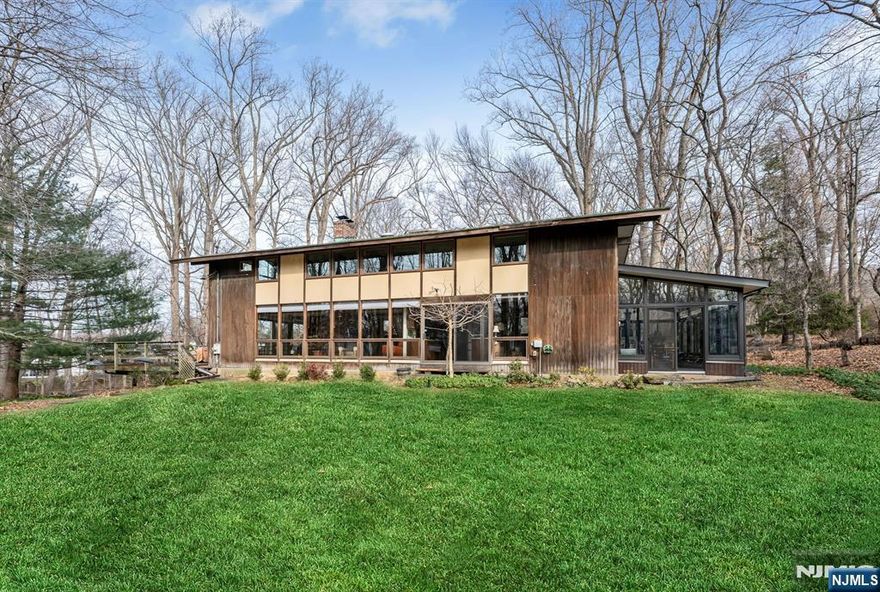 Prime East Hill location on approximately 2.25 acres, offering exceptional privacy and a serene, natural setting. Set back over 485 feet between two farms, this remarkable property feels like a private retreat while being just minutes from the GW Bridge. The sun-filled 4-bedroom, 2.5-bath contemporary chalet-style home features abundant natural light streaming through newer windows and open, flowing living spaces. The main level includes a living room with wood-burning fireplace, kitchen, dining room, family room, powder room, laundry room, and a recently rebuilt sunroom. A large deck off the living room overlooks the picturesque grounds. The second floor offers four bedrooms and two full baths, including a primary suite, along with two walk-in closets. Move-in condition with numerous updates, including newer roof, windows, air conditioning system, drainage, and underground sprinklers. Additional features include multi-zone baseboard heat, central air, and a two-car garage. Ideally located near Closterâ€™s award-winning schools, vibrant downtown, nature center, library, recreation programs, and more. A truly rare offering.