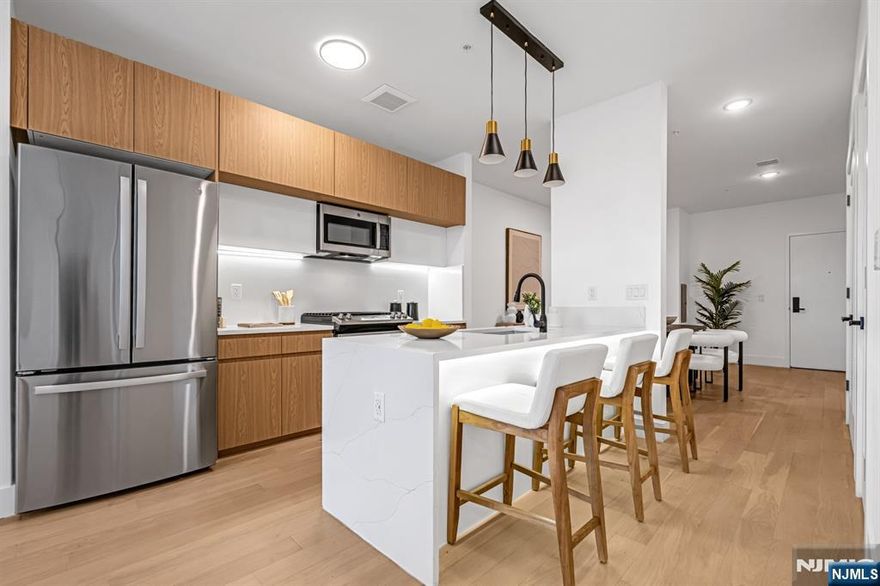 SELLER PAID CLOSING COSTS- LIMITED TIME OFFER. PENTHOUSE UNIT- Introducing Tailor House Union City, Hudson Countyâ€™s newest boutique luxury condominium. This intimate elevator building offers just 48 thoughtfully designed residences, combining privacy, sophistication, and urban convenienceâ€”all just 15 minutes from NYC by bus. Tailor House redefines modern living with oversized 1- and 2-bedroom homes featuring open-concept layouts, soaring 9â€“10 ft ceilings, and generously sized bedrooms. Sleek kitchens are outfitted with waterfall quartz countertops, European-style two-tone oak cabinetry, GE Professional Series appliances, and select units include contemporary islands. Bathrooms evoke a spa-like feel with floor-to-ceiling porcelain tile, glass-enclosed showers, and marble-topped vanities. Residents enjoy upscale amenities including a fully equipped fitness center, stylish lobby, landscaped garden terrace, and smart security with Swiftlane intercoms. Assigned parking is included, with additional spaces available for purchase, and a 5-year tax abatement adds even more value. Nestled in the heart of historic Union City, Tailor House offers a refined lifestyle where modern design meets everyday convenience.