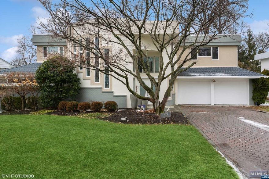 Spectacular contemporary home. Impressive 2 story atrium entry with large skylight offering beautiful natural light. An open floor plan including an eat in kitchen, den area, and formal dining space. Beautiful, newly renovated kitchen outfitted with stainless-steel high-end appliances, double sinks and two dishwashers. Upstairs offers 3 large bedrooms and new renovated bathroom. The finished basement includes two large bonus rooms, ample space for playroom, workout area, and wet bar. Main floor primary bedroom with large walk-in closet and en-suite bathroom.