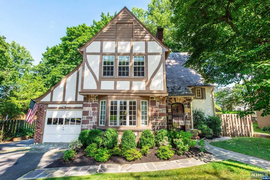 Perfectly appointed & updated, this 4 BR, 3.1 Bath Tudor in the desirable Gregory section combines elegance with livability! Charming stone & stucco facade invites you into a bright vestibule showing off the refinished hw flrs. formal LR, w/custom WB fp leads into a sleek formal DR & huge FR w/new hw flrs, a bank of windows & recessed lighting. The bright & beautiful white kit boasts granite countertops & new backsplash, fridge & dishwasher as well as stunning radiant-heated slate flooring. A powder rm completes the 1st flr. Upstairs, you'll find a spacious Primary w/renovated ensuite, plus 2 more ample BRs & hall bath w/marble double vanity & rain shower! The finished 3rd flr beckons guests w a lovely BR & full bath. Basement houses the laundry, gym & plenty of storage. The BY is a true oasis! Private & lush w/new fencing, the paver patio is perfect for relaxing & dining; there's a firepit for cool nights & a play area. jitney to NYC train is right on the corner!