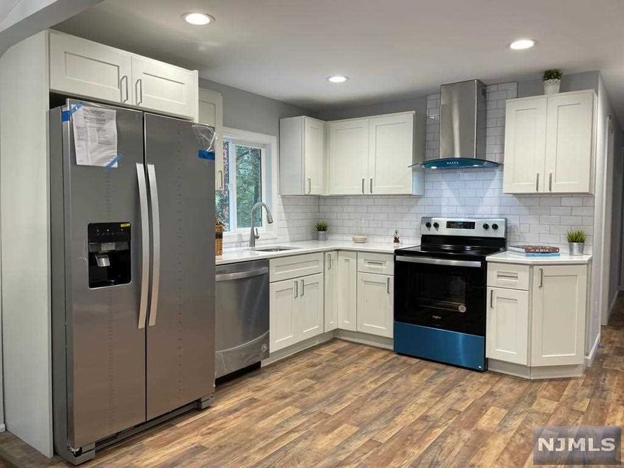 Totally renovated from top to bottom an expanded 3 BR/2Ba ranch in a picturesque Upper Greenwood Lake. Everything is new: septic, well pump, w/heater, siding, roof, wiring, kitchen, baths, etc. Family room on the ground floor with a wood burning stove and a wet bar is a perfect place for people gathering and entertainment. Master bedroom with views of the lake is bright and airy, has a WIC. The house has recess lights throughout the house, gorgeous bathrooms with a tub on the main floor, with glass doors shower give you luxury yet cozy feeling of a new home. Big backyard, and oversized garage with the loft where you can have a studio for your remote business. Very close to the beach and the best Pizza in the town. Easy commute to NYC by express bus from nearby. Lots of shopping and all year around entertainment: apple picking, wine tasting, swimming, boating, hiking, skating, and skiing at Mountain Creek 7 miles away. Perfect cute house for all year round or vacation living.