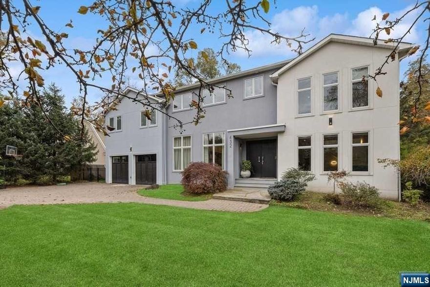 Discover modern elegance with Smart Home capabilities on Closter's coveted East Hill. Built in 2010, the home boasts of 12Ft ceiling in the sun-drenched living room, enriched by a fireplace and radiant heating floors, and features a cozy family room, a versatile ensuite guest room or home office, and powder room. The minimalist design of the open-concept plan is accentuated by a recently renovated European kitchen with hi-end pro-style appliances. Enjoy the serene views through the stunning floor-to-ceiling windows, or from the outdoor covered patio, overlooking the newly fenced private garden. Ascend to the 2nd floor to find 4 exquisite ensuite bedrooms, all with radiant bathroom flooring. The grand primary suite showcases twin walk-in closets adjoining a spacious bathroom, complete with a Jacuzzi and a multi-jet shower. Descend to the basement to unveil an entertainment retreat that includes a full bar, media room, gym, powder room, and an escape to your backyard sanctuary.