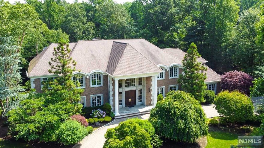 NEW PRICE! Experience luxury living on a quiet cul-de-sac in prestigious Alpine. This stunning 9,000sf estate sits on 1.5 acres of landscaped grounds with a pond & waterfall. The 2 story dramatic foyer invites you into a modern, expansive design w/open floor plan leading to a sun-filled Great RM w/soaring ceilings, floor-to-ceiling windows, fpl & French doors to a stone terrace overlooking private grounds. The Gourmet Kitchen & Breakfast RM opens to Music/PlayRM or the Grt RM. The main floor also offers a Bqt- size Dining Rm, LR, Mahogany office w/access to terrace, 2 guest suites, 2 Powder Rms & Mud Rm. The 2nd floor offers a Primary Suite w/Sitting & Dressing RM, MBTH w/Steam Shower & Jacuzzi, plus 2 ensuite Bdrms w/Private Lounge. The Lower level boasts a Gym, Yoga Rm, Theater, 1BR, 2BTHs, Office & Fam Rm w/access to covered patio w/BBQ--perfect for entertaining or relaxing. 3-car garage. Great community & great school; low taxes. Modern bucolic living only minutes from NYC!