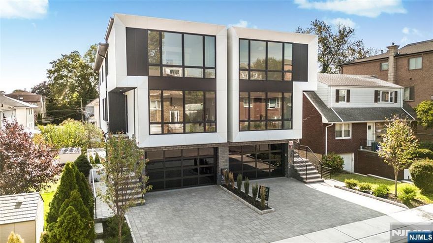 Designed & Built by SILVERLINE - 4-level, 4,410 GSF Oversized Contemporary Townhome Featuring a PRIVATE ELEVATOR & PRIVATE HOME THEATER. 3BD, 5.5BA, 2 private decks, and fenced backyard. Floor to Ceiling Andersen windows and European wide plank flooring complement the modern design. The chefâ€™s kitchen boasts European cabinetry, integrated fridge/freezer, wine cooler, and oversized island. Ground level includes a full bath and backyard access. Second level offers a guest room, full bath, living area, and balcony. Third level showcases the kitchen, dining, and living area with deck. Top level features a 3 bedrooms, 3 baths. The large primary bedroom has its own spa-like bathroom with heated floors, freestanding tub, and rainfall shower. Smart home features, multi-zone HVAC, central vacuum, security cameras, and oversized modern all-glass garage door with WiFi opener. Prime location minutes from the GWB.