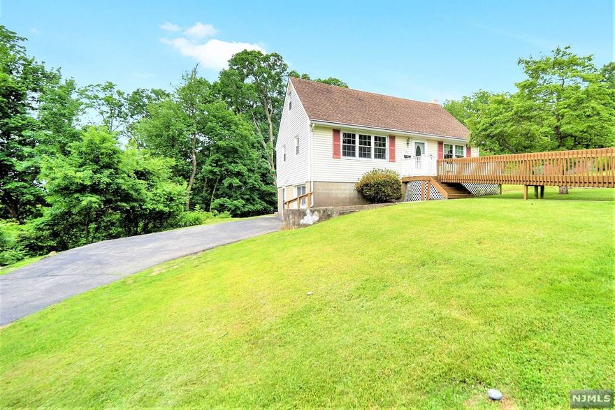 Charming Cape Cod style home, with lovely curb appeal in a private setting with a 1/2+ Acre and no through traffic! Front entry includes living room, dining room, updated kitchen with SS Appliances, full bath & first floor bedroom. Hardwood floors throughout this level. Second floor boasts two bedrooms and a full size bath to share. A walk in closet in the hallway answers any additional storage needs. Hardwood floors are under the newly installed carpet in one of the bedrooms. Stairs to the lower level for additional VERSATILE LIVING SPACE - family or additional sleeping area, full bath with a shower, kitchenette, and a huge storage utility room - this walk out space is perfect for entertaining or POTENTIAL FOR A MULTI-GENERATIONAL, EXTENDED FAMILY. Private backyard surrounded by greenery for outdoor enjoyment - enjoy the decking and lower level patio too. Upgrades in recent years include Newer Windows & Gutter Guard. This home has a great floorplan, well loved by the