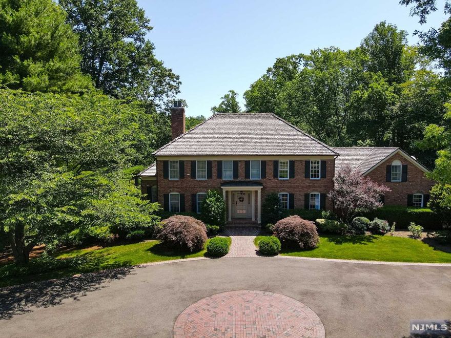 This 5 BR, 3.1 bath elegant brick colonial situated on one of the most sought-after streets in Bernardsville. No expense was spared in this home crafted with attention to detail using only the highest quality finishes. Sitting on 5 acres of serene & beautifully landscaped grounds with rolling lawns,mature trees, resort-like pool & spa, spring-fed pond, small beach area. Also features a flower garden, vegetable garden,fire pit,detached two-port garage with loft storage, & attached three-car garage. Enter through the foyer to find a formal DR,formal LR with built-in surround sound, office, sun room, Fam Rm, and custom chef's kitchen with a Viking Refrigerator & Gas Range. 2nd flr features 4 BRs, a private primary suite boasting a stunning walk-in closet, ensuite full bath,sitting room.This magnificent home is also perfect for entertaining with a full, finished lower level that flows seamlessly to the outdoor living spaces. Heavy hand-split cedar shake roof & copper gutters (2020)