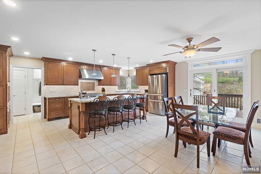 This beautiful ranch home offers 3,128 sq ft of space and sits on 0.86 acres of land in the desirable East Hill section of Upper Saddle River. The large primary suite features a walk-in closet and en suite bathroom with a shower and tub. The main floor offers 3 more bedrooms and 2 other full bathrooms and lots of closet space. It is perfect for home chefs and hosts, with an ideal layout featuring a formal living room, large dining room, custom gourmet eat-in kitchen, and a family room with a wood-burning fireplace. The chef's kitchen features a Blue Star 22,000 BTU oven range, dishwasher, new high-end Bosch fridge, and a separate convection oven built into the 8.5x4ft center island with a prep sink. Two separate finished basements provide an ideal home office with a half bath and a separate TV/game room. There is also plenty of storage space. Central air and vac, large deck, front and rear lawns, an oversized 2-car garage, and a wrap-around driveway complete the package!