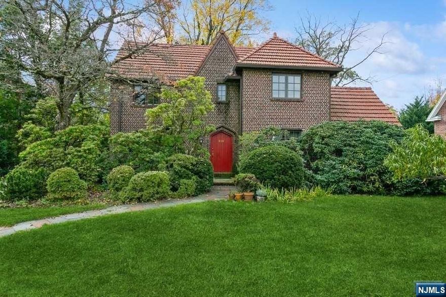 Gracious Tudor Colonial on prime block in heart of West Englewood section of Teaneck; Beautifully maintained & updated with loads of charm; Hardwood floors; 1st fl offers huge Living Room w/FPL & custom built-ins, Formal Dining Rm, Family Rm, PR, and lovely Updated Kitchen w/corian counters, SS appliances & pretty Breakfast nook; 2nd Fl has spacious Primary Suite w/window seat, several closets (one cedar) & FBTH, a large 2nd BR, 3rd BR or home office & hall FBTH; 3rd fl accessed by spiral staircase to lovely 4th BR w/vaulted ceiling & skylight, updated FBTH & more storage space. Roomy full basement offers lg semi-finished recroom w/laundry area, workshop & 1/2bth, additional workshop space, wine cellar/storage & utilities. Gas Heat (furnace updated 2013, former UST removed), Central A/C (3rd fl has separate electric heat/A/C); Recessed radiators; 2-Car Detached Garage & paver driveway; Beautifully landscaped yard w/flowering trees & bushes. Close to Houses of Worship.