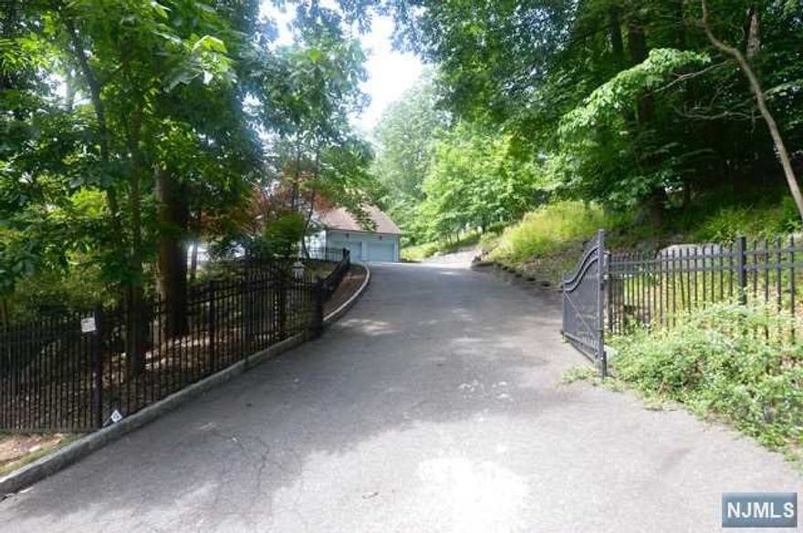 This wonderful contemporary home is located in prestigious Winton Gate of Franklin Lakes once owned by a famous basketball player who was also an actor. This home is situated on top of the hill. The home offers a wrap around deck, 2 story entry foyer, great room with stone fireplace/cathedral ceiling open to the dining room with cathedral ceiling which opens to the large kitchen with professional appliances a chefs delight. First floor master bedroom, master bath with 2 sinks shower stall/jacuzzi tub. Full walk out basement with a bedroom full bath and very high ceilings. Throughout the entire home is high ceilings and high doorways. Owners installing new septic system. Owners are open to reasonable offers! must see home!