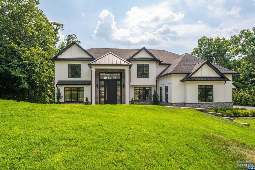 Situated within the prestigious Hills section, this exquisite colonial, built in 2020, offers a sense of seclusion while being local to shopping, dining, schools, and amenities. The grand two-story foyer welcomes you into a luxurious, naturally lit living space that flows seamlessly from the living room to the dining room and into a chef's dream kitchen that boasts custom cabinetry, a center island, and top-of-the-line appliances, including a Wolf stove top and dishwasher, and a Sub-Zero fridge, microwave, and double oven. A cozy family room complete with an electric fireplace, a half bathroom, and a home office round off this level. Ascend stairs to discover a lavish primary suite with an en suite bathroom, a walk-in closet, and a private balcony to soak in breathtaking views. A princess suite with its own bathroom, two additional bedrooms, a common bathroom, and a convenient laundry room equipped with a washer and dryer make this level perfect for everyday living.