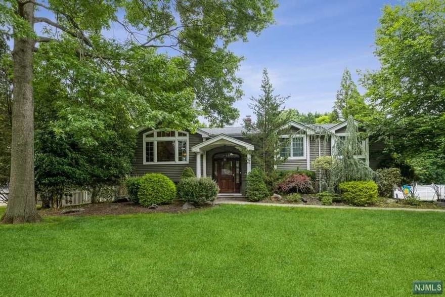 Bright and tastefully modern turnkey, single family home on a huge lot located on a beautiful, quiet street. This sun filled home exudes classic pride of ownership, starting upstairs with the renovated chef's kitchen & dining area, granite counters/tiled backsplash with high end SS appliances. This level has 3 bedrooms and 2 full baths. Relax and unwind with your favorite wine on the deck located right off the kitchen. New hardwood floors throughout. The master bedroom features 2 walk-in closets, cathedral ceilings and a jacuzzi tub. Downstairs you can sit around the fire with your gas fireplace. Enjoy privacy with another full bedroom and an office area off the den that can be used as a 5th bedroom. There is a separate entrance that can be used as an in-law suite. Some finishing touches include a separate entrance that can be used as an in-law suite & a Koi pond. Take advantage of all this plus an easy commute to Manhattan and a top rated school system.