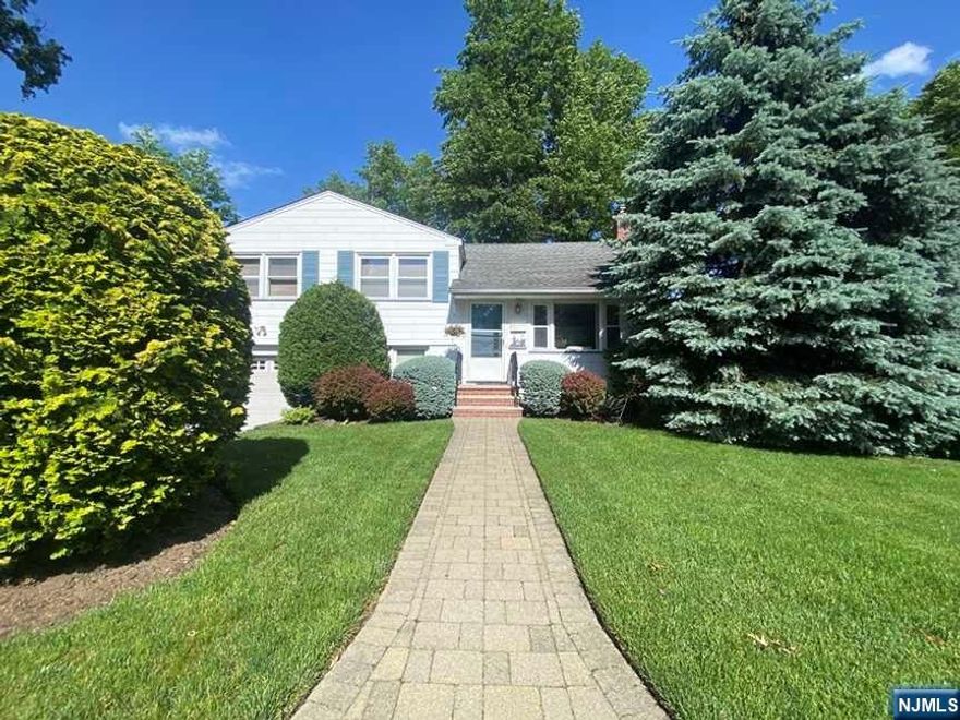 Just move right in to this 3 bedroom 1.5 bath home that has space for all your needs. Located on a tree line street in Bergenfield, this well loved home awaits it's new owner. The spacious living room with open floor into the dining room makes for great entertainment space with door to large deck that overlooks a well manicured lawn, paver walkways and gardens. Up just a few steps you will find 3 bedrooms with good size closets and a full bath. Family room or home office is ready on the ground level with access to the garage, laundry, half bath, mudroom/storage and door to the yard. And... there is more, a good size basement is ready to turn into a gym, playroom or whatever your needs are. Central air, a generator and many more items prove that the attention to detail in this home is apparent. Close proximity to schools, transportation, parks and shopping. Come make this your next place to call home. It is truly is a home sweet home.