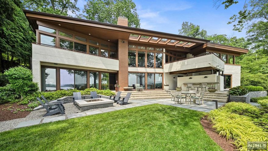 This absolutely stunning property presents an unparalleled combination of sophistication and refinement. The front facade of this classic modern work of art is purposely deceptive and understated... in contrast to the drama of the lakeside elevation with its striking views, bluestone patios and lush gardens. Collaboratively designed by a protege of the famed Frank Lloyd Wright, the architecture, design, and finishings are all carried out in impeccable taste and stand second to none. Walkout lower level office can easily become a 4th BR. Walls of glass seemingly disappear as one of NJ's most sought after private lake communities & its lifestyle become your very own. Some addl features include: custom refrigerated wine room, professional grade home gym, fully integrated Crestron smart home system, custom cherry millwork, whole house generator, int/ex audio, steel beam dock & so much more. Only 35 min to NYC. Schedule your private tour today!