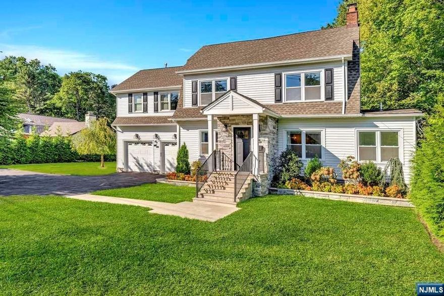 Discover this move-in-ready masterpiece! A bluestone pathway leads to an elegant entrance w/ new portico + vestibule. The open concept living space ft. inviting LR, boasts intricate moldings, contemporary frpl w/ surround sound, exquisite PR, + mudroom. A captivating freshwater aquarium highlights an additional seating area that connects seamlessly to the luxurious kitch, showcasing a 13-foot "waterfall" island, smart fridge, floor-to-ceiling cabinets w/ integrated TV, +pantry/coffee station. Beyond, a grand chandelier adorns a breathtaking, formal DR with vaulted ceilings +skylights. An in-wall beverage/humidor cabinet adds elegance +natural light floods the space which can be transformed into GR. Enjoy breathtaking views from the unique covered double deck, ft. an outdoor kitch, dining space, lounge area/hanging bed, heat lamps, & 8 person hot tub. Large, sodded backyard w/ privacy hedges- a true oasis! An adjacent bluestone patio leads to the lower level w/ gym, new bath, wine