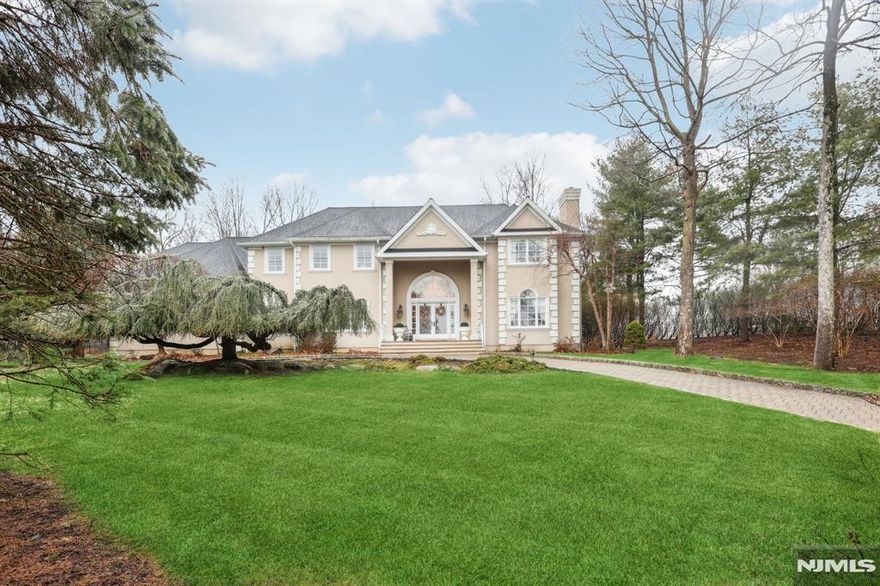 This exquisite 4-bed, 4-bath estate offers luxury and privacy on a 1.2-acre cul-de-sac lot. Featuring oversized bedrooms, 10' ceilings, and hardwood floors, the home exudes elegance. Enjoy a grand living room with a fireplace, a spacious great room with a second fireplace, and a first-floor library/office. The gourmet kitchen boasts a Sub-Zero refrigerator, granite countertops, and a sunlit breakfast room. The primary suite is a true retreat with a private fireplace, spa-like bath, and generous closet space. Three additional oversized bedrooms provide ample room for family and guests. Outdoors, relax by the heated inground pool with a new liner (2023) or entertain on the expansive patio. A circular driveway with elegant paver bricks and Belgian block curbing adds sophistication. Additional highlights include a heated 3-car garage, central vacuum system, newer stucco exterior, and a spacious high-ceiling basement perfect for a gym, media room, or extra living space. Conveniently located near top-rated schools and shopping, this exceptional home blends luxury, privacy, and convenience.