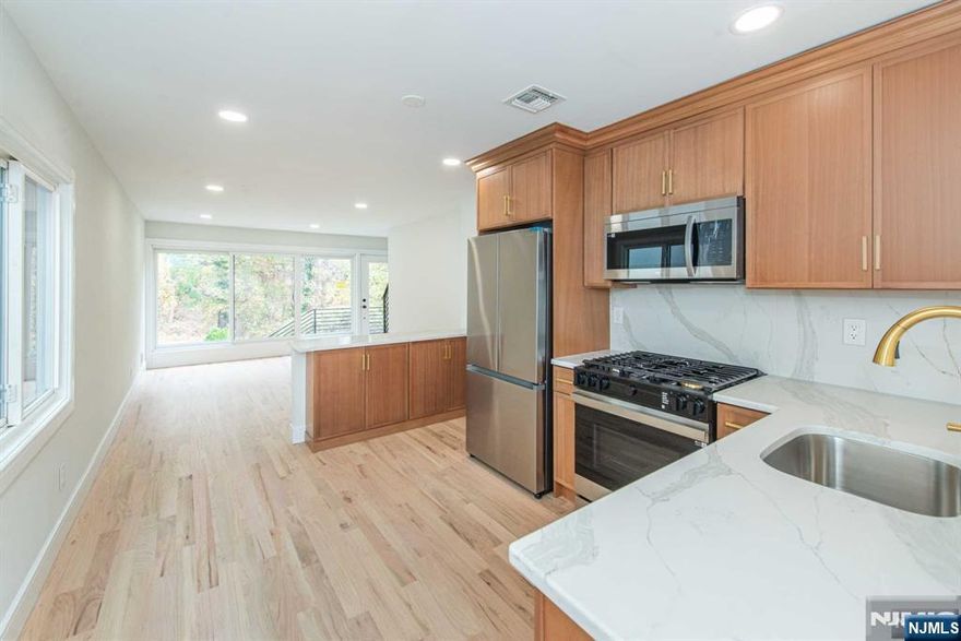 This renovated brick home offers the perfect blend of comfort, style, and functionality. Boasting 4 spacious bedrooms and 2 modern bathrooms, the home features an open-concept layout with a bright and airy living room, dining area, and kitchen ideal for both relaxing and entertaining. Two bedrooms are conveniently located on the main floor, along with a well-appointed bathroom, while the upper level hosts two additional bedrooms and another full bathroom, ensuring plenty of privacy and space for the whole family. Natural light pours into every room, creating a warm, welcoming atmosphere throughout. The property is turnkey, ready for you to move right in and enjoy. Step outside to a beautifully landscaped backyard, perfect for outdoor gatherings or simply relaxing in a serene setting. The home also offers a 1-car garage and easy access to NYC transit, making your commute a breeze. Don't miss the opportunity to own this move-in-ready gem!