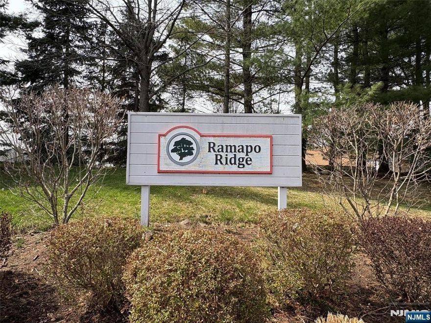 Ramapo Ridge 2 bedroom 2 full bath 2 half bath end unit with tons of windows to bring natural sunlight all day long!. Detached garage with 2 parking space. Entry foyer to Family room with 2-story cathedral ceiling & fireplace, marble powder room, Formal dining area with sliding door to patio, Updated eat-in-kitchen with Wolf stove, stainless appliances, granite countertop, tiled backsplash. Sunny & bright office/den with sliding door to deck. Hardwood floors throughout. Second floor with master suite, walk-in closet with make-up area, master bathroom with tub & shower. Hall Full bathroom & Bedroom. Finished basement with access to backyard. Playroom, office/Den with bay window, laundry & 1/2 bath, plenty of storage.