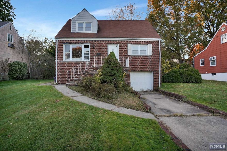 Expanded cape has some nice upgrades. First floor: living room, large eat-in kitchen, 2 bedrooms, full bath. Second floor: 3 bedrooms, full bath. Basement has a finished rec room, full bath, summer kitchen with sink, cooktop and microwave. 1-car attached garage. Lovely back yard. Across the street from Overpeck Park, which provides lovely greenery and privacy. Close to shopping, restaurants, schools, houses of worship. AS IS SALE.