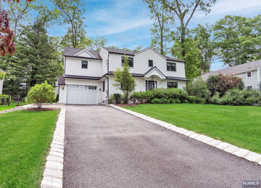 Pristine Modern Colonial extensively remodeled by a reputable Ridgewood Builder in the heart of Ridgewood's sought-after Willard district. Light & airy open concept with a spacious kitchen with quartz countertops, a large kitchen island & high-end appliances. The kitchen opens to a family room filled with natural light featuring a sleek stone fireplace and views of the beautiful exterior hardscape & landscaping. Large mudroom with custom cabinetry off the garage entrance. Living room & dining room complete the 1st floor. Upstairs offers a large primary bedroom with full bath & walk-in closet, 3 additional bedrooms and full bath. Interior design elements include trendy tile work in the modern all-new bathrooms, modern light fixtures, custom built-ins and hardwood floors throughout. The full, finished basement includes a gym, flexible space and full bath. Prime location for NYC commuters, just a short distance to the Ho-Ho-Kus train & just blocks away from top-ranked public schools.