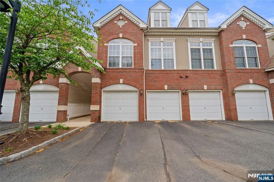 Bright, spacious and ideally located townhouse, just minutes from NYC transportation, major highways, shopping, schools, and local restaurants.This beautifully maintained 2-bedroom, 2.5-bath home boasts an open floor concept with high ceilings and oversized windows that fill the space with an abundance of natural light. The first floor features a spacious living and dining room combination with a cozy gas fireplace and sliding doors leading to a private patio overlooking peaceful green space. The modern kitchen offers a breakfast bar, ample cabinetry, and great functionality for everyday living and entertaining. A powder room, convenient laundry/utility room, and direct access to large garage complete the main level.The second floor features a spacious primary suite with a private full bath with double vanity, stall shower, jetted tub, and a walk-in closet. Enjoy your morning coffee or relax in the evening on the private balcony off the primary suite. A generously sized second bedroom and an additional full bath complete the upper level.Additional highlights include new central A/C, new hot water heater, one car garage and plenty of parking. Enjoy outstanding community amenities including an outdoor swimming pool, tennis courts, clubhouse, and walking/jogging trails exclusively for residents.Perfect for owner occupied or investment!