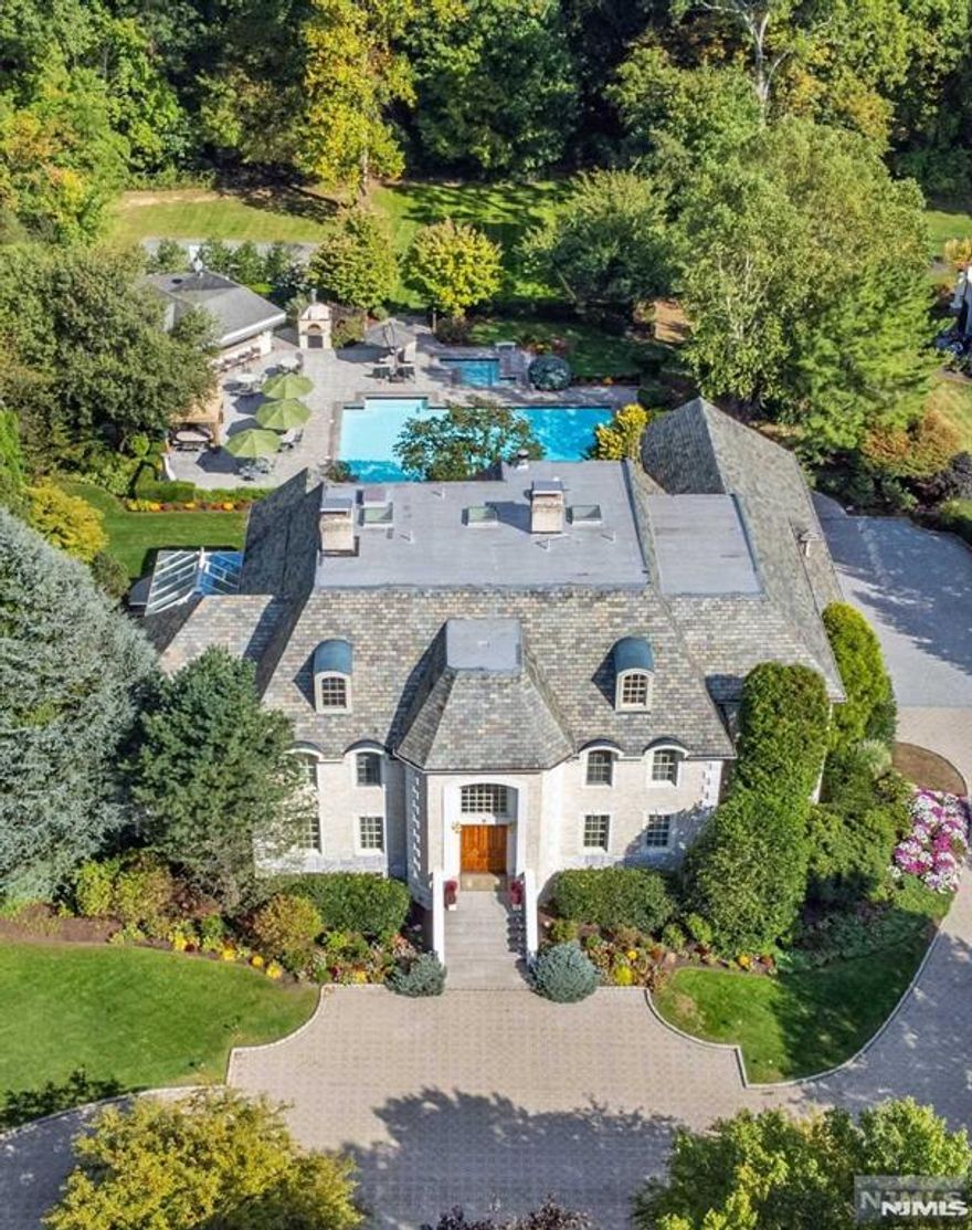 Country club living in your own backyard! Exquisite custom all brick estate w/Vermont slate roof, located in double cul-de-sac upscale neighborhood. Privately set on over 3 acres. This extraordinary estate offers luxurious living & timeless beauty inside & out.The estate offers 4 levels of living, a massive outdoor entertaining area featuring a cabana pool house w/kitchen & full amenities, 25x50 heated pool & separate spa, granite patio, sports court, & paver circular driveway.No expense spared. Adorned w/Swarovski crystal chandeliers, granite, marble & wood flooring, dentil moldings. 5 bedrooms, 7.3 baths, two-story grand foyer, formal living rm w/fireplace, formal dining rm w/ 2 French doors to stunning conservatory, a true chef's kitchen w/top-of-the-line appliances, w/4 ovens, 2 d/w, 2 refrigerators, great rm w/3-sided fireplace, full bar, built-in entertainment center, & 2 French doors to patio. Lavishly appointed primary suite w/fireplace, 2 French doors to veranda overlooking lush grounds, 2 custom walk-in closets, primary bath features 2 private powder rms, jetted tub & over-sized shower. Two add'l en-suites, two add'l bedrooms & main bath. Third level is complete w/maid's quarters, & storage. Full finished walk-out basement w/full bar, rec room w/fireplace, family room, gym, full bath & wine cellar. Natural gas generator, 13 zone baseboard heating, 9 zone central air, 12 zone irrigation, low level exterior lighting, heated driveway bordering garages.Too much to list!