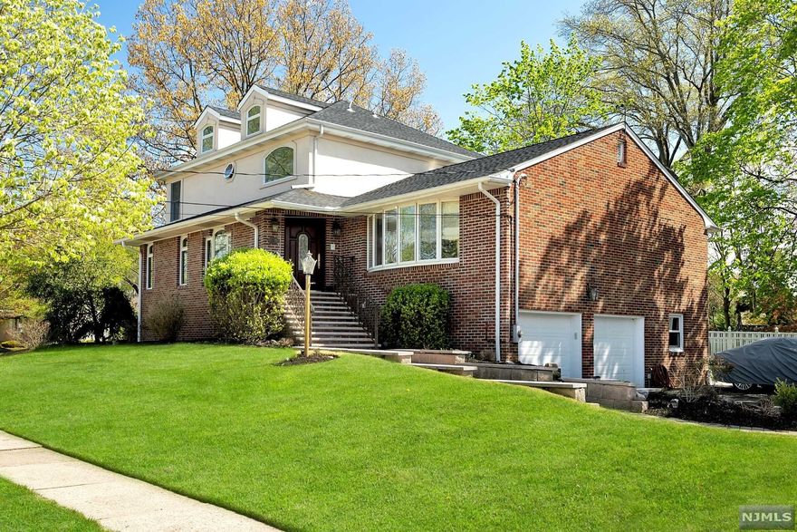 You will instantly fall in love with this brick colonial with majestic curb appeal in a great neighborhood! This home is perfect for entertaining and hosting large families. It features 5 bedrooms, 4 full baths, and 1 half baths. The first floor has a large formal living room with cathedral ceilings and bow window, large formal dining room, Eat in kitchen w/ SS appliances, granite counters and double oven, powder room, den could be another bdrm and large primary suite w/ 3 closets including a walk-in. Jacuzzi tub, shower, double sink and tumbled marble throughout. Walk up the stunning staircase to the 2nd level with 3 additional bedrooms, one with a jack and jill bathroom and the other is an ensuite. Floored, full height walk up attic with tons of storage. Finished basement with great room addition, gas fireplace with floor to ceiling stone, game, laundry and utility rooms, full bathroom, office/bdrm, access to wrap around covered patio, yard and garage from this level. Hardw