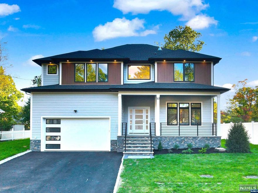 This gorgeous home boasts approx 4500 sf of fin. living space across 3 floors, on a 0.28-acre lot in a quiet st. A 2-story foyer welcomes you, showcasing wide plank H/W flooring throughout, extensive trim, custom millwork & fin. closets. The spacious living areas incl formal living rm, dining rm & a kitchen & family rm with an electric FP. Kit is equipped with high-end SS appliances, large center island with one-sided waterfall, quartz countertops & ceiling-ht cabinetry. The 1st fl features a bedrm for guests, a full ba, and a mudrm for added convenience. The 2nd fl is home to 4 bedms, 3 bathrms, and a laundry rm, incl 2 en-suites. The primary suite offers a walk-in closet & a spa-like ba with a soaking tub, stall shower & dual sinks. fully finished bsmnt incl a bedrm/office, a full ba, a large rec area with a built-in bar & a theater. Walking distance to the NYC bus, shopping, restaurants, schools, library, rec facilities & places of worship, 10-year builder's warranty