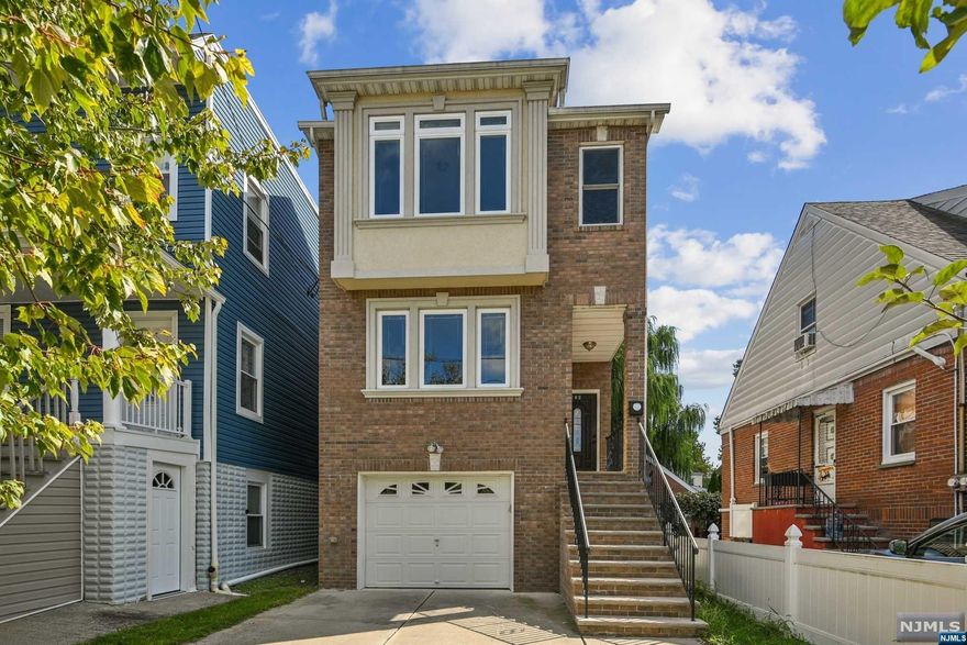 Built in 2014, this like-new home has it all. Through the front door, the entry hall leads past a powder room into a beautiful open-concept living, dining, kitchen space with sliding doors that open onto the deck overlooking the private backyard. The kitchen has stainless appliances and granite counters. Proceeding up a few stairs is a large family room or flooded with natural light. The 2nd floor features 2 nicely scaled bedrooms that share a hall bathroom, plus a wonderful primary bedroom suite with 2 walk-in closets and a full bath. Added bonus is laundry also on 2nd floor. The finished basement has good space for rec room, playroom, or office, a storage room, and entrance to the one car garage. Brand new energy efficient hot water heater and HVAC. Google Home remote online climate control. Remote garage door. Gleaming hardwood floors. Great location just a few blocks to train and buses to NYC. Schools very close by.