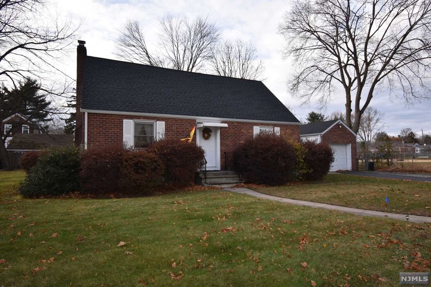 LOVELY, CAPE/COD HOME WITH 3 BEDROOMS, 2 FULL BATHS SET ON A LARGE, GORGEOUS PIECE OF PROPERTY MEASURING 111' X 100'. THE FIRST FLOOR HAS A LARGE LR W/WOOD FP THAT OPENS TO THE LIGHT AND BRIGHT DINING AREA. THE DINING AREA HAS BUILT-IN SHELVING FOR LOTS OF STORAGE. THERE IS AN EAT-IN-KITCHEN WITH MAPLE CABINETS AND A STEP DOWN TO THE SCREENED IN PORCH FOR OUTDOOR SUMMER DINING. A LARGE, 1ST FLOOR, MASTER BEDROOM AND HALL BATH COMPLETE THIS FLOOR. THE SECOND FLR HAS 2 LARGE BEDROOMS WITH A BACK DORMER FOR EXTRA SPACE AND ANOTHER FULL BATH. FEATURES INC: HARDWOOD FLOORS ON 1ST FLOOR, NEW ROOF, NEW HWH, NEW MIRCOWAVE OVEN, JUST POWERWASHED, UPDATED BATHS; NEW TOILETS AND VANITIES, DOUBLE-WIDE DRIVEWAY, ETC. GORGEOUS, PARTIALLY FENCED YARD WITH DECK OFF THE ENCLOSED BREEZEWAY. WALK TO NYC TRANSPORTATION, SHOPPING AND GRANT FIELD/PARK. WONDERFUL LOCATION; NEAR THE ORADELL BORDER.