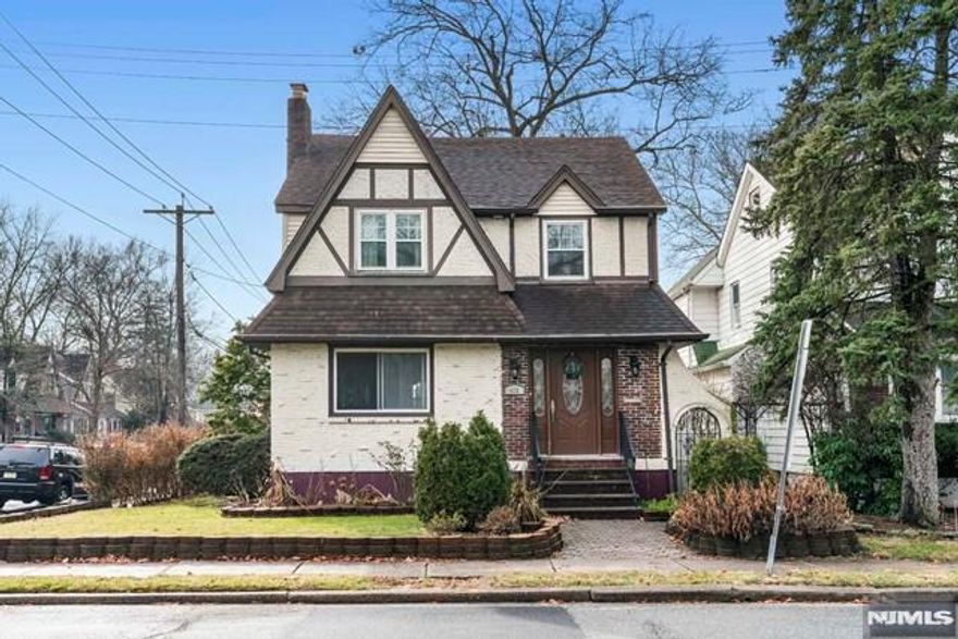 Conveniently located and well maintained Colonial-Tudor style home in a desirable area of Teaneck. First floor features large living room and formal dining room which connects to a completely updated kitchen. Second floor offers three bedrooms and a full bath. Full unfinished attic for lots of storage. Finished basement features a large family room, summer kitchen, full bath. Central AC, and hardwood floors throughout. Great paved patio an one car detached garage, plus driveway fits 2 additional cars. Walking distance to NYC transportation and very close to schools and shopping!