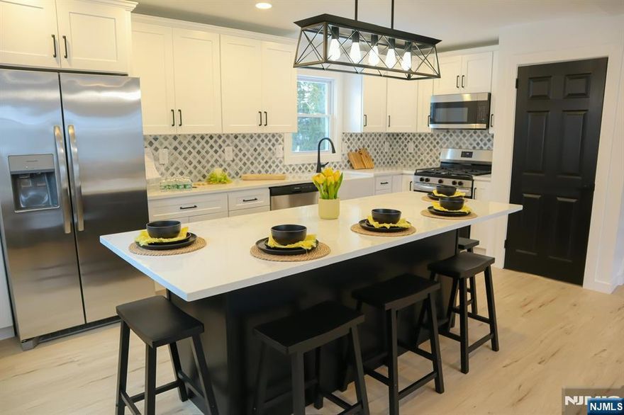 Welcome to 78 Poplar Ave, a stunningly remodeled 3 bedroom, 2 bath bi-level home offering modern comfort and style in a desirable neighborhood. Step inside to find brand new vinyl flooring, energy efficient windows, and a bright open layout perfect for entertaining. The kitchen shines with stainless steel appliances, sleek cabinetry, ample counter space and a center island with seating. The next level provides flexible living space ideal for a family room, office, or bedrooms with a fully renovated full bath. Upstairs, you'll find a spacious primary bedroom with large closets, dressing room, and a brand new primary full bath. Outside, enjoy a private backyard and convenient access to local parks, schools , and major highways plus just minutes to NYC transit. Move right in and start your chapter in this turn key Little Ferry gem!