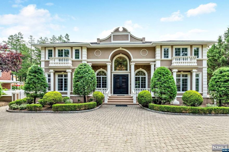 One of the most iconic and spectacular residences to have ever been built in Paramus. This custom colonial boasts a brand new stucco facade with ornate details inside and out. Grand double staircase in the entrance foyer creates a breathtaking first impression. 7,200+ sq ft on the 1st & 2nd floors alone plus 2,700+ sq ft basement with 10-12 ft ceilings. This palatial home offers 7 bedrooms and 5.5 bathrooms with amenities galore. Fabulous chef's kitchen w. 3 sinks, professional grade appliances including 48' Wolf Cooktop, new wine cooler & backsplash. Stunning 2 story great room. 3 bedrooms on the main level & 4 bedrooms on 2nd level including massive Primary Suite w. vaulted ceilings, private office/sitting room & Juliette balcony. Fully finished basement boasts Rec Room, Bonus Rooms, room for a theater, & more. Outdoor Kitchen, 4 car garage, various terraces & balconies, plus circular driveway. Truly a dream home in the heart of Bergen County with breathtaking views & property.