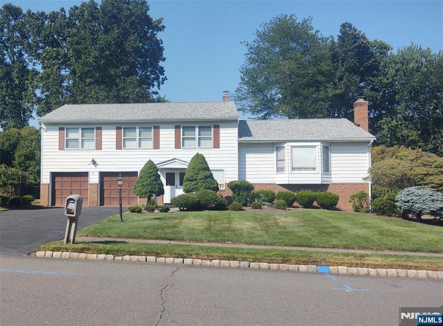 Welcome home to this spacious split-level, perfectly designed for comfort and entertaining! Featuring 4 oversized bedrooms, 2.5 baths, gleaming hardwood floors, and sun-filled living spaces, this home offers room for everyone. Enjoy cozy nights by the wood-burning fireplace or summer BBQs in the fully fenced, flat backyard. Huge storage room with high ceiling offers finishing potential. Recent upgrades include new roof (2025, 50-yr transf. warranty), newer boiler & CAC motor, 200-amp electric, and 7-zone sprinkler. South-facing front helps keep the driveway clear in winterâ€”move right in and start making memories!