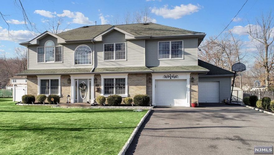 Picture perfect inside & out! This pristine Colonial sits on a peaceful street with the updates & finishes you desire. The outstanding craftsmanship is evident the moment you step inside with attention to design, comfort & convenience. The main level is delightful with an open feel, great space & lots of natural light. The MBR suite has a vaulted ceiling, walk-in closet & luxurious bathroom w/two person Jacuzzi! All four bedrooms have a feature wall & Elfa closet organizers. A large fenced-in backyard to enjoy with lush green grass, paver patio, pergola & more. The exterior is maintenance free with true curb appeal. A terrific location in a Blue Ribbon school district close to shopping, restaurants & transportation (half mile to train station). This home has so many tasteful enhancements, you must see to appreciate!