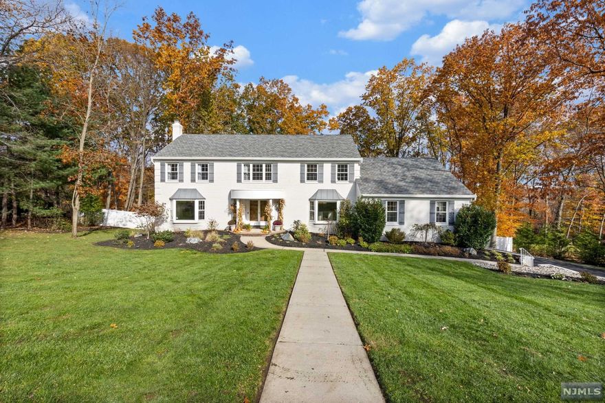 Welcome to this MOVE-IN ready home! This oversized custom CHC in the Carriage section of Wyckoff is located on one of the nicest streets in town. The beautiful hardwood flooring greets you as you enter the contemporary two-story foyer and continues throughout the home. Eat-in Kitchen updates inc Quartz countertops and backsplash, GE Monogram Induction Cooktop & Convection Oven. There is a great room to entertain and includes a vaulted ceiling, remote skylights, FPLC and a wet bar with access to a lg deck. The newly renovated en-suite bath inc all Porcelanosa tile and fixtures with dual shower heads and heated flooring. Hi-tech and high-eff updates to the home inc tankless hot WH, HVAC units (2), nest thermostats(4), ring flood light cameras, & doorbell, custom & recessed LED lighting, front load W/D on 1st floor. The home has been pre-wired with a sound system with a custom network, Huge Basement, EV Charger Ready, Epoxy floor/Garage, New driveway fenced yard abundant storage