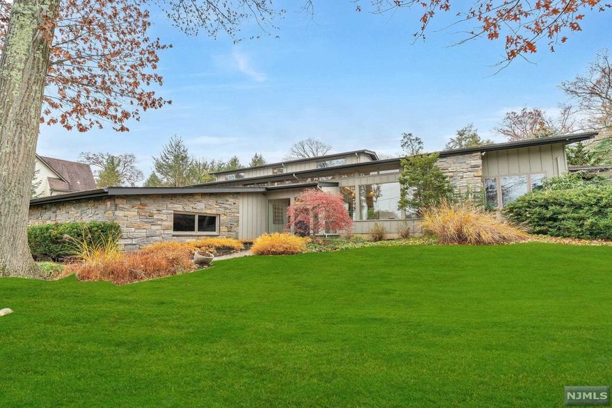 Exquisitely designed SLEEK contemporary home to fit today's lifestyle! Fabulous Open Floorplan w/a mid-century modern urban vibe! Uninterrupted movement throughout the interior w/a strong indoor-outdoor connection. Subtle sophistication, clean lines, smooth textures. Complimenting the architecture of the home are SS radiant floors & modern hardwood. Large panes of glass showcase & flood the space w/natural light. 40' wall of sliders in the solarium blur the line between indoors & out, promoting a serene atmosphere. All rooms are large w/a cool, hip vibe.1st floor primary BR ensuite is right out of a magazine. 2nd BR or Office. Open Kitchen, dining area & family room w/oversized fplc adds to open concept living. 2nd floor has 2 large BRs w/FHB. The full finished lower-level blends cohesively continuing the hip vibe w/a bar, game room, media room & full bath. This extraordinary home offers over 4600sf +appx 1800sf finished lower level in a natural environment.